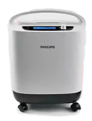 Ein tragbarer, weißer Philips Sauerstoffkonzentrator auf Rollen mit einem Tragegriff oben und einem digitalen Display auf der Vorderseite.
